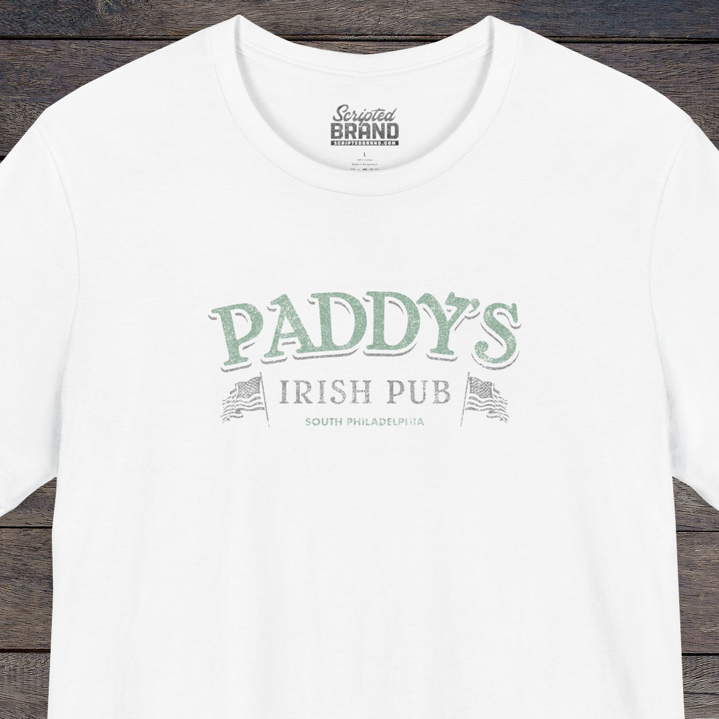 Front view of a white colored soft Bella+Canvas 3001 short-sleeve t-shirt tee featuring the green Paddy's Pub logo from the TV Show It's Always Sunny in Philadelphia, in a vintage distressed style, sold by ScriptedBrand.
