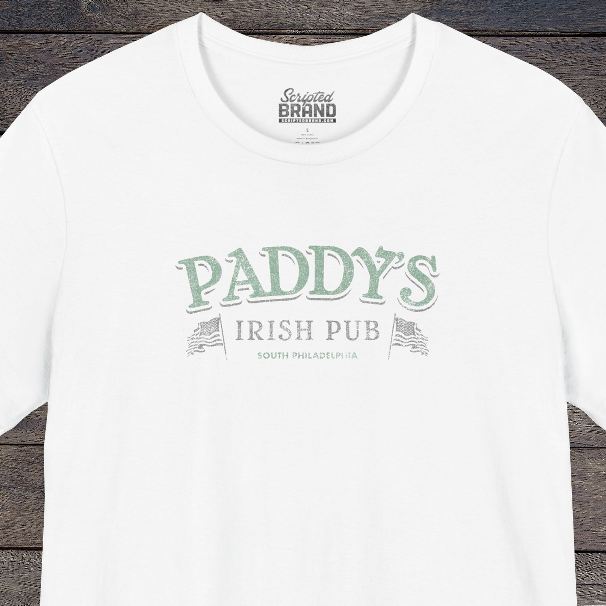 Front view of a white colored soft Bella+Canvas 3001 short-sleeve t-shirt tee featuring the green Paddy's Pub logo from the TV Show It's Always Sunny in Philadelphia, in a vintage distressed style, sold by ScriptedBrand.