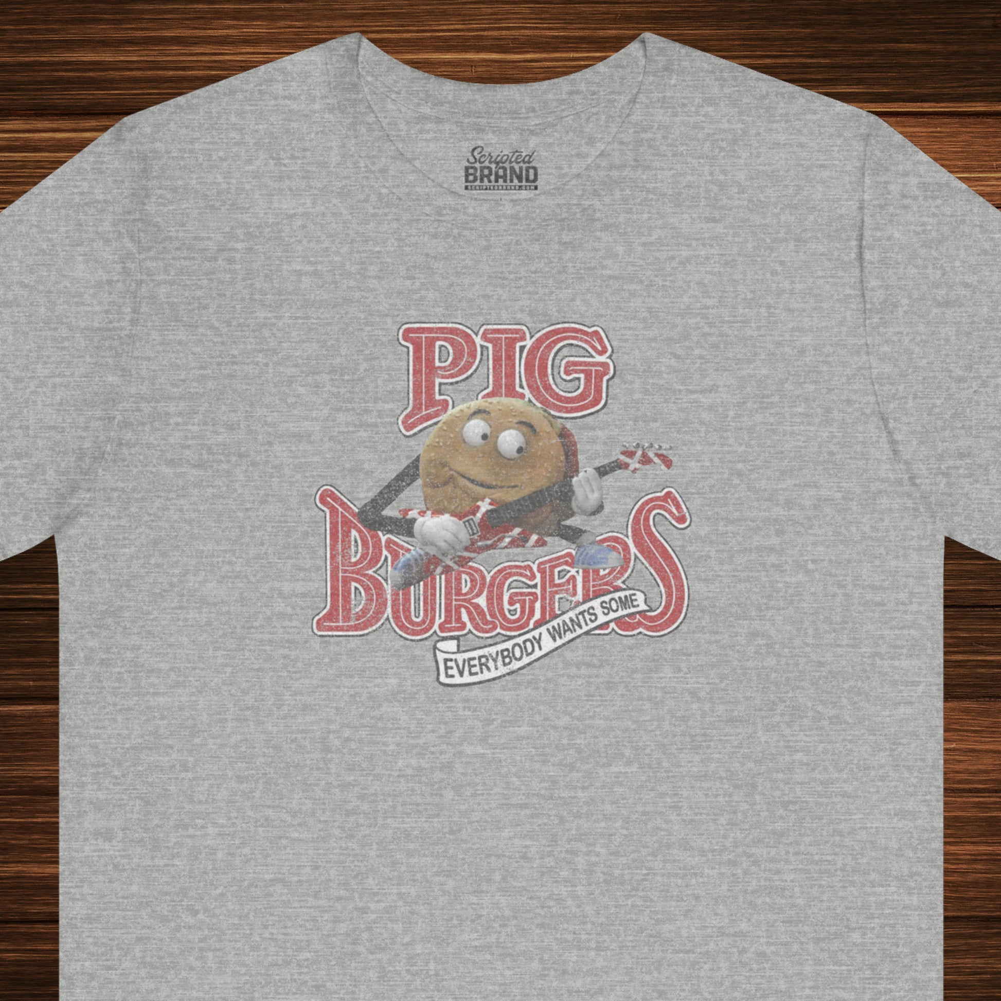 Front view of an athletic heather grey colored soft Bella+Canvas 3001 short-sleeve t-shirt featuring a graphic of the fictional Pig Burgers logo from the movie Better Off Dead, along with the Van Halen singing hamburger playing guitar, with the small subhead phrase EVERYBODY WANTS SOME. The graphic is designed in a vintage distressed style, sold by ScriptedBrand.