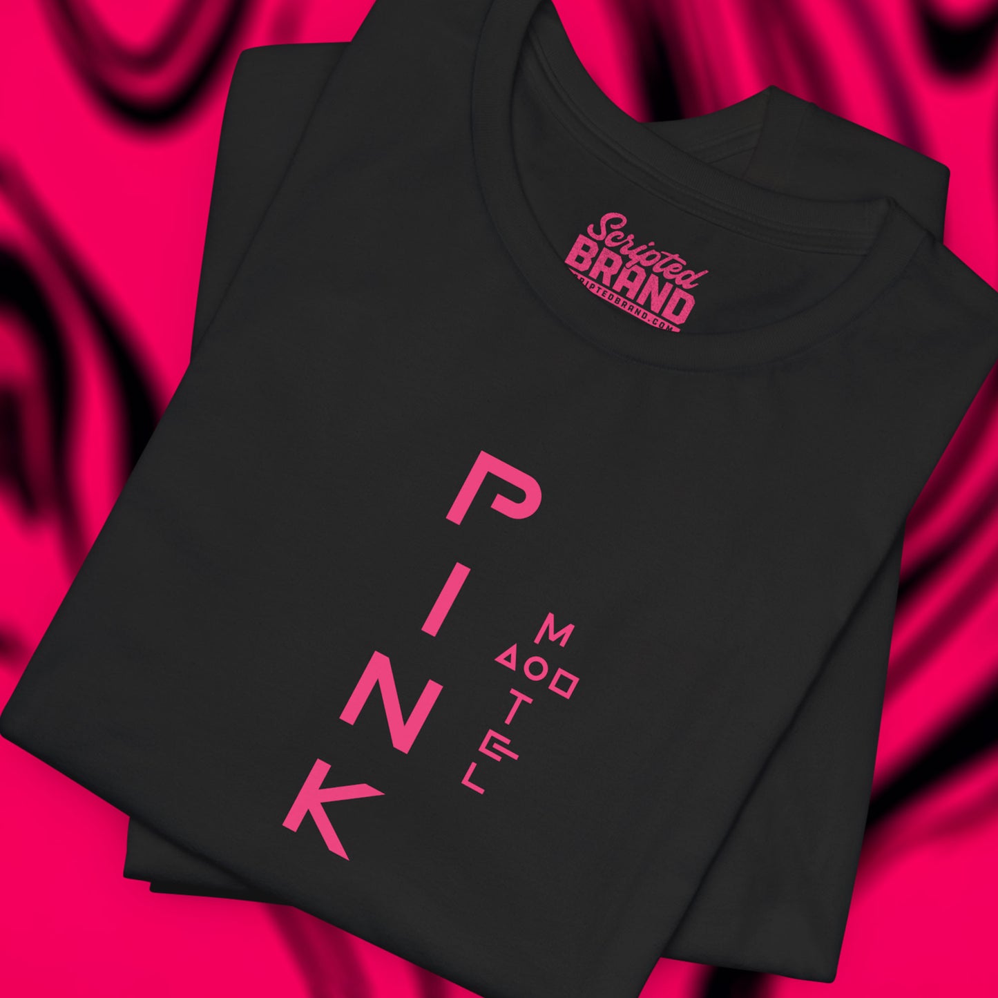 Folded black colored soft Bella+Canvas 3001 short-sleeve t-shirt featuring a pink logo graphic of the fictional Pink Motel inspired by the TV series Squid Game, in a vintage distressed style, sold by ScriptedBrand.