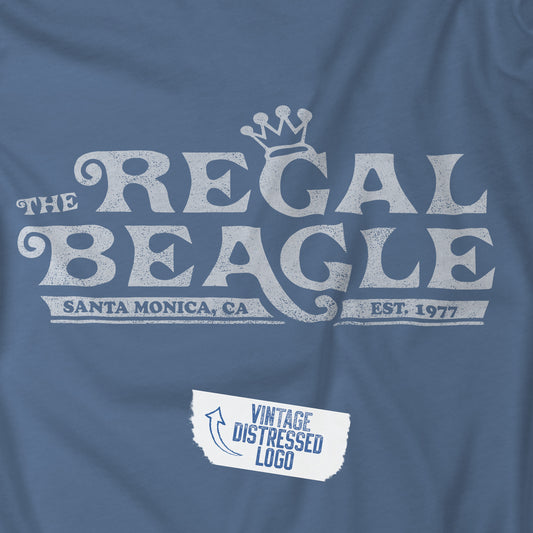 Closeup view of a Lavender Blue colored soft Bella+Canvas 3001 short-sleeve t-shirt featuring the Regal Beagle logo from the TV Show Threes Company in a vintage distressed style.