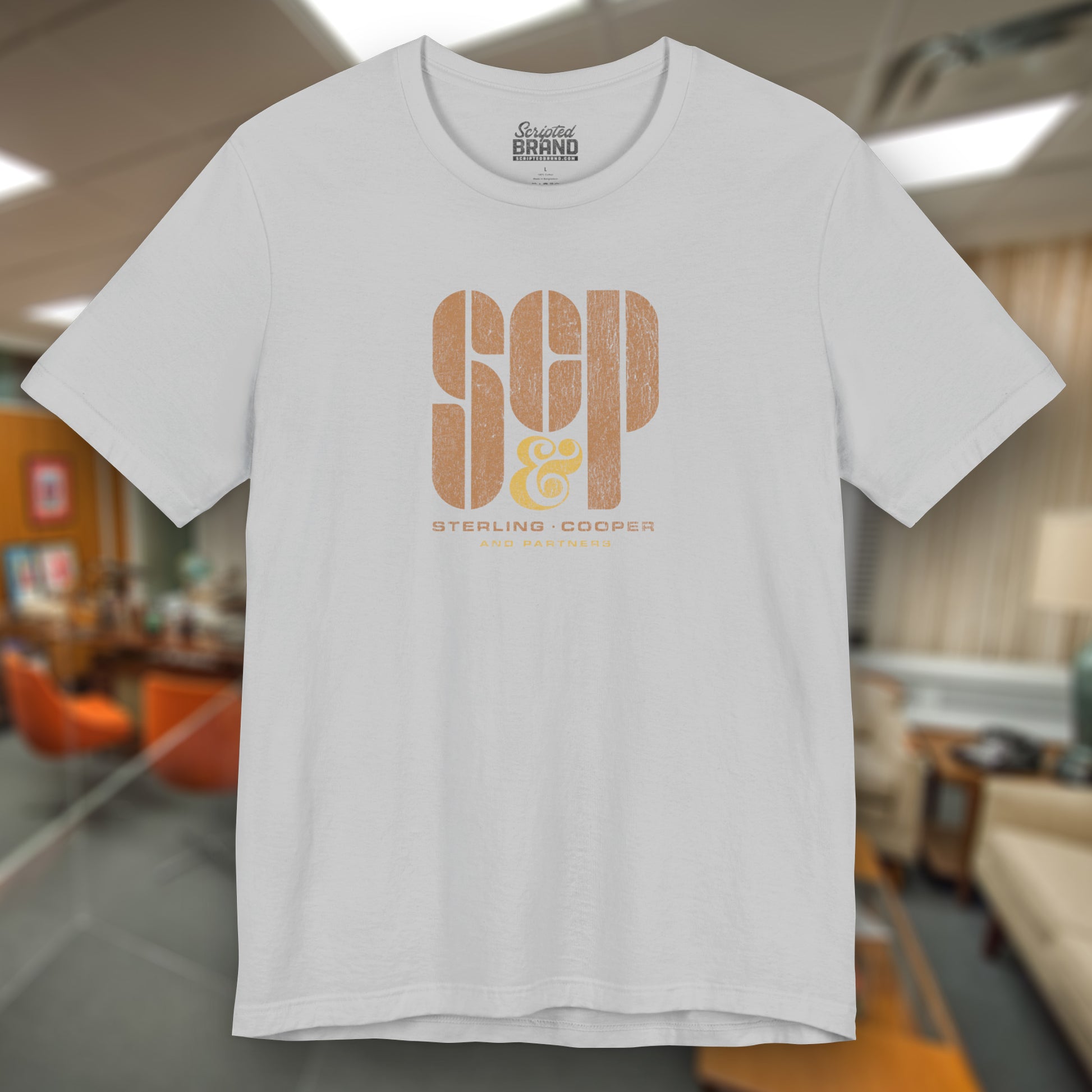 Front view of a solid athletic grey colored soft unisex Bella+Canvas 3001 short-sleeve t-shirt featuring the Sterling Cooper & Partners logo graphic from the TV Show Mad Men in a vintage distressed style, sold by ScriptedBrand.