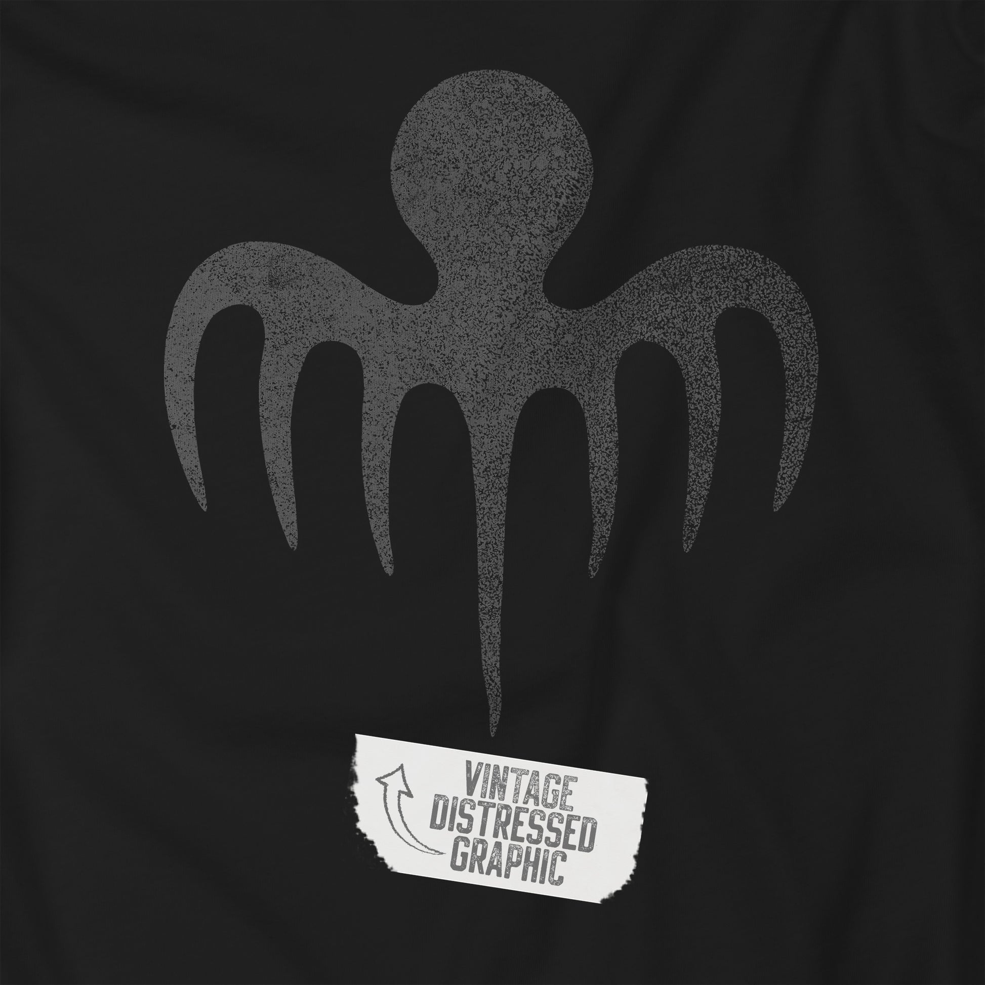 Closeup view of a black colored soft Bella+Canvas 3001 short-sleeve t-shirt featuring a logo graphic of the fictional criminal organization Spectre, inspired by the James Bond movie franchise, in a vintage distressed style.