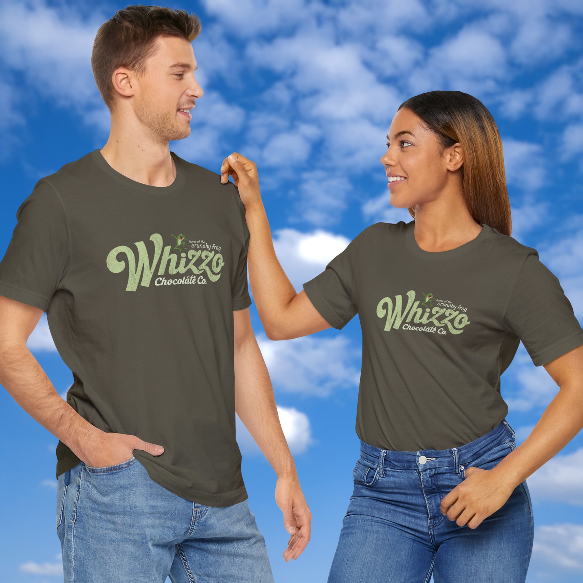 2 models wearing t-shirts with vintage Whizzo Chocolate Co. logo, inspired by Monty Python, featuring “home of the crunchy frog” graphic.