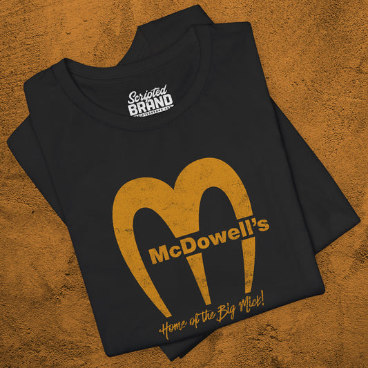 Black t-shirt featuring the McDowells logo from the movie Coming to America in a vintage distressed style.