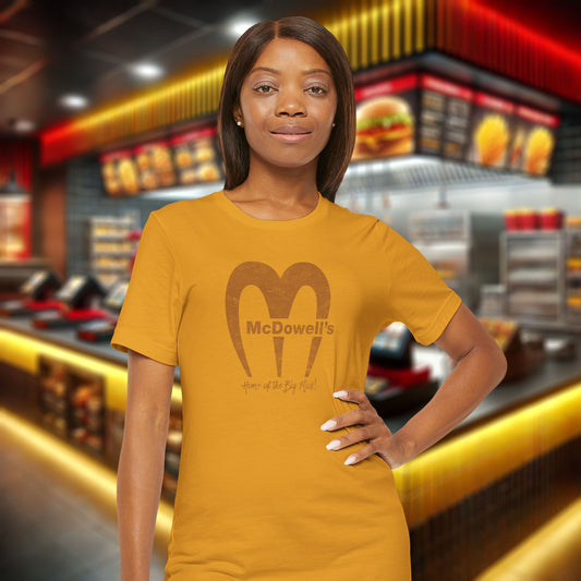 Woman wearing a mustard yellow t-shirt with 'McDowell's' logo in a fast-food restaurant setting