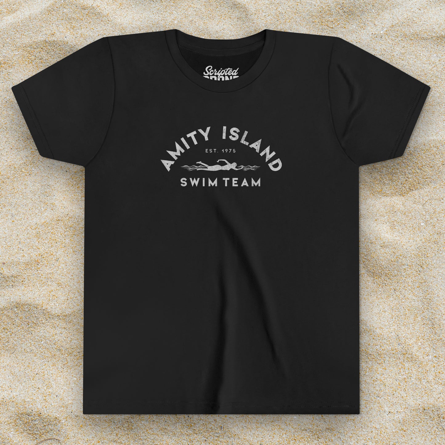 Front view of a black colored Soft unisex Youth Sizes Bella+Canvas 3001Y short-sleeve t-shirt featuring an Amity Island Swim Team logo graphic, designed by ScriptedBrand, and  inspired by the movie Jaws in a vintage distressed style.