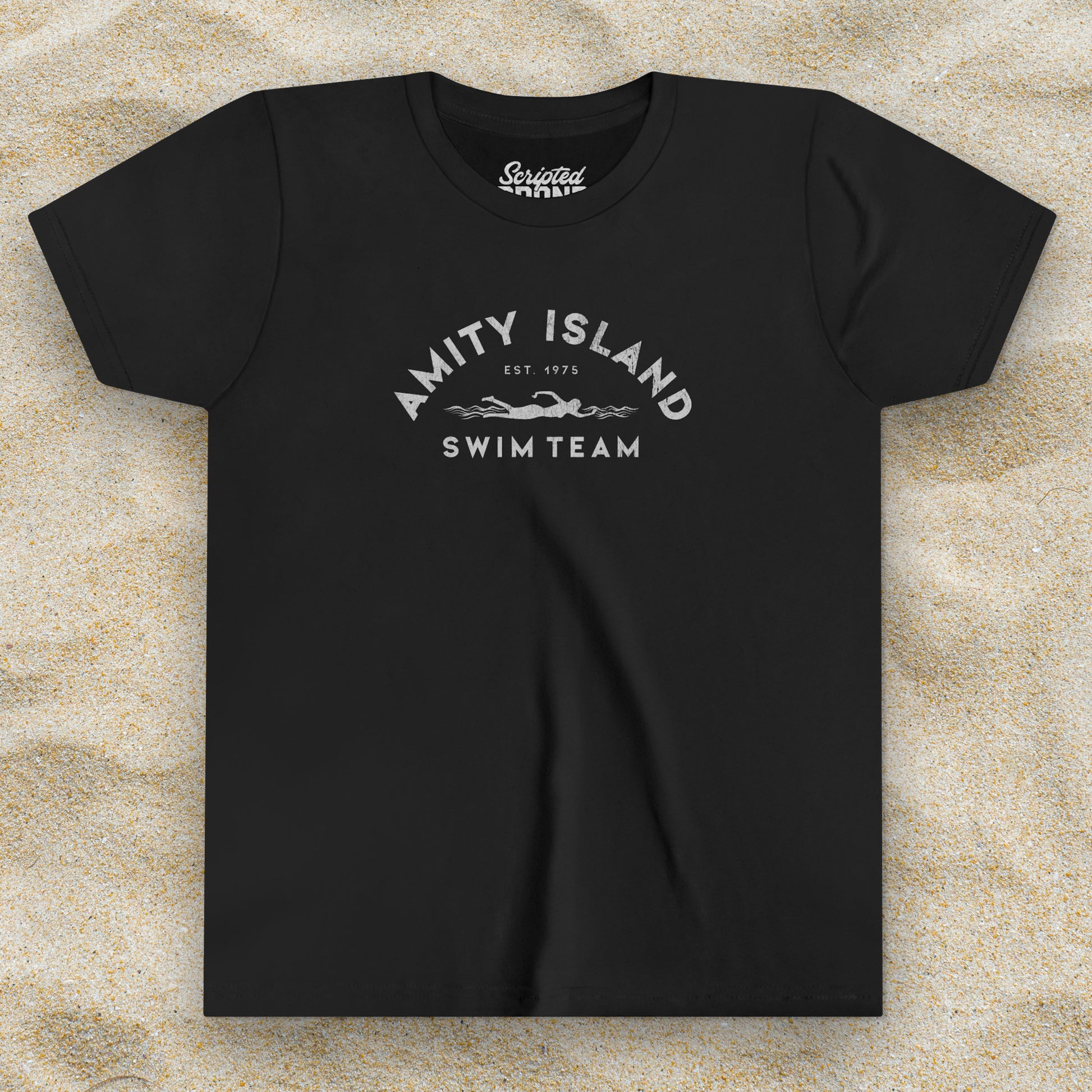Front view of a black colored Soft unisex Youth Sizes Bella+Canvas 3001Y short-sleeve t-shirt featuring an Amity Island Swim Team logo graphic, designed by ScriptedBrand, and  inspired by the movie Jaws in a vintage distressed style.