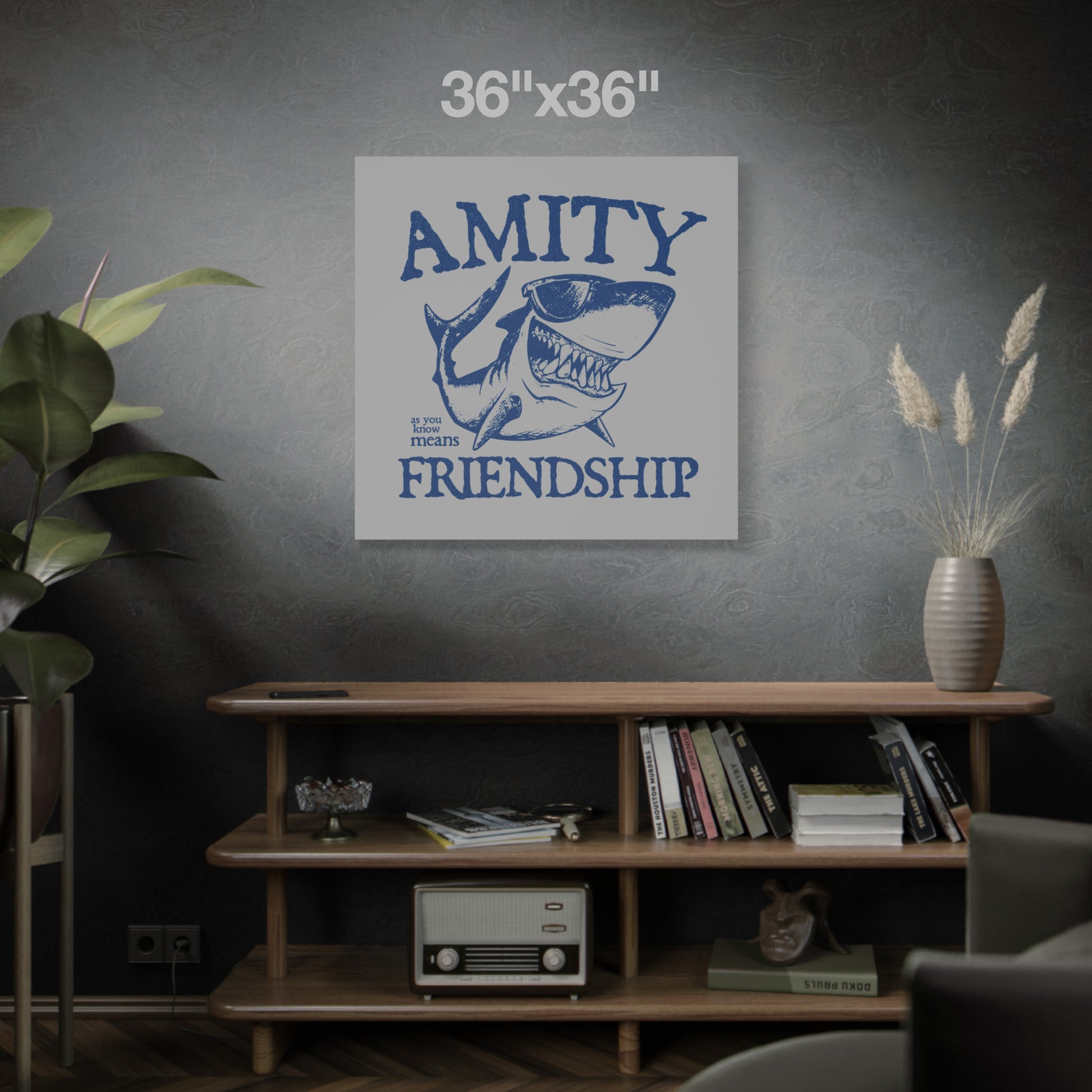 36 x 36 Funny Amity Island shark wall art canvas print inspired by Jaws with “Amity Means Friendship” and shark in sunglasses, on a dark wall