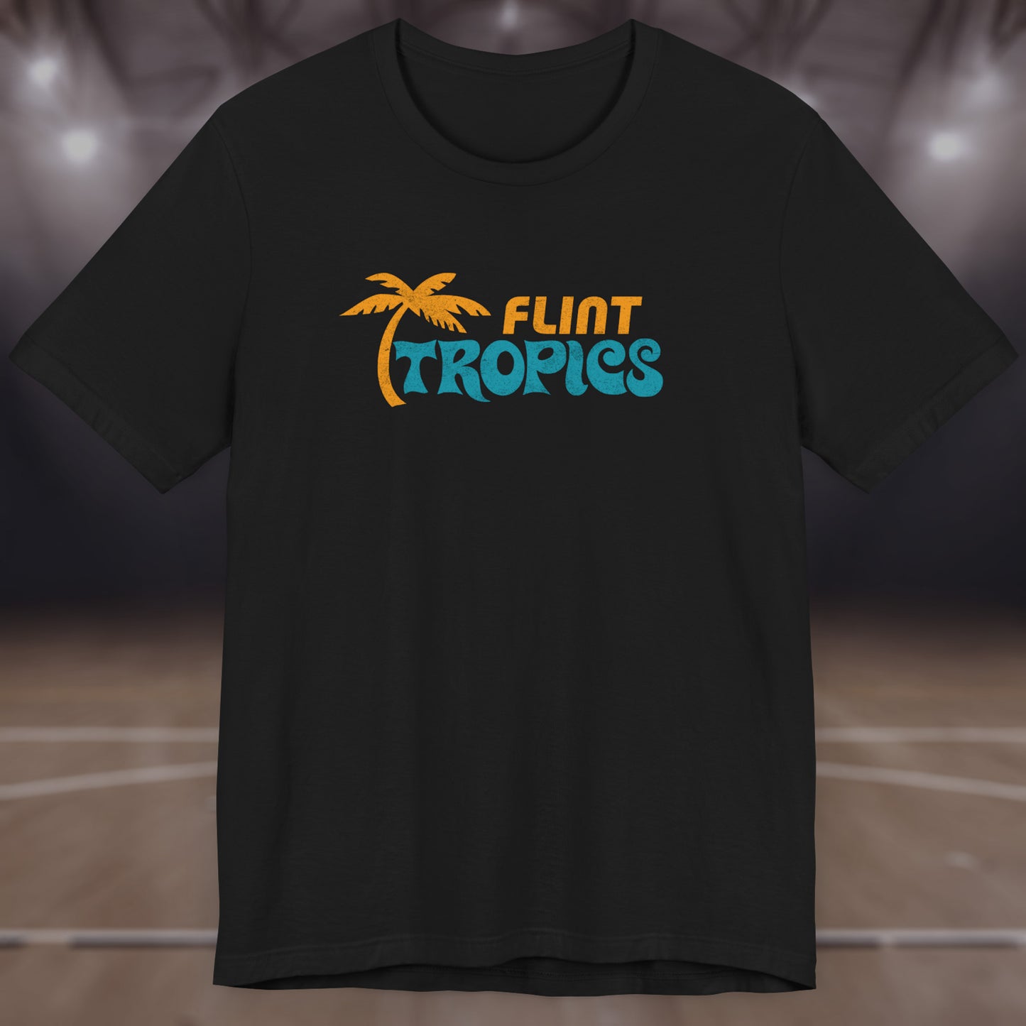 Front view of a black colored soft Bella+Canvas 3001 short-sleeve t-shirt tee featuring the Flint Tropics logo from the movie Semi-Pro, in a vintage distressed style, sold by ScriptedBrand.