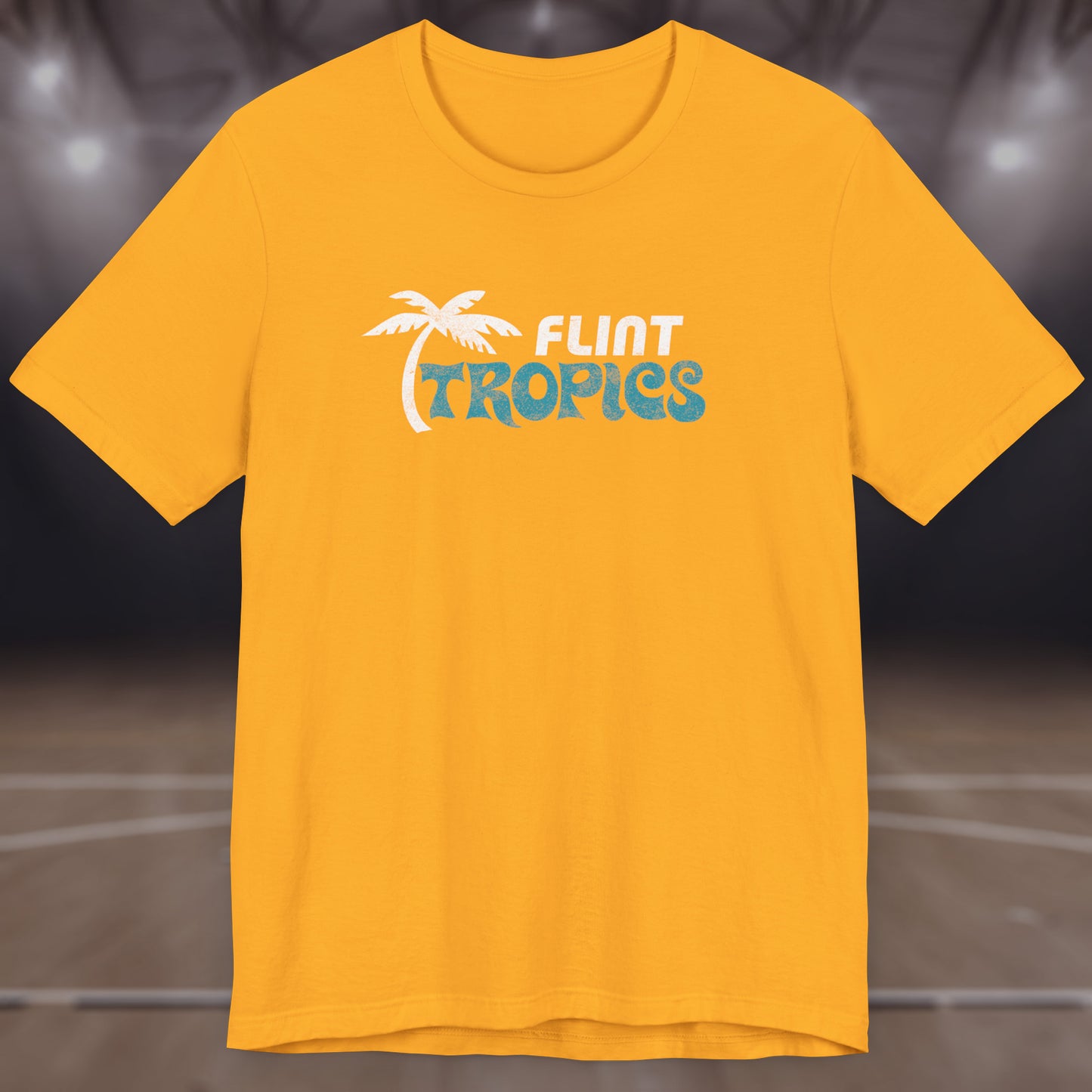 Front view of a gold colored soft Bella+Canvas 3001 short-sleeve t-shirt tee featuring the Flint Tropics logo from the movie Semi-Pro, in a vintage distressed style, sold by ScriptedBrand.