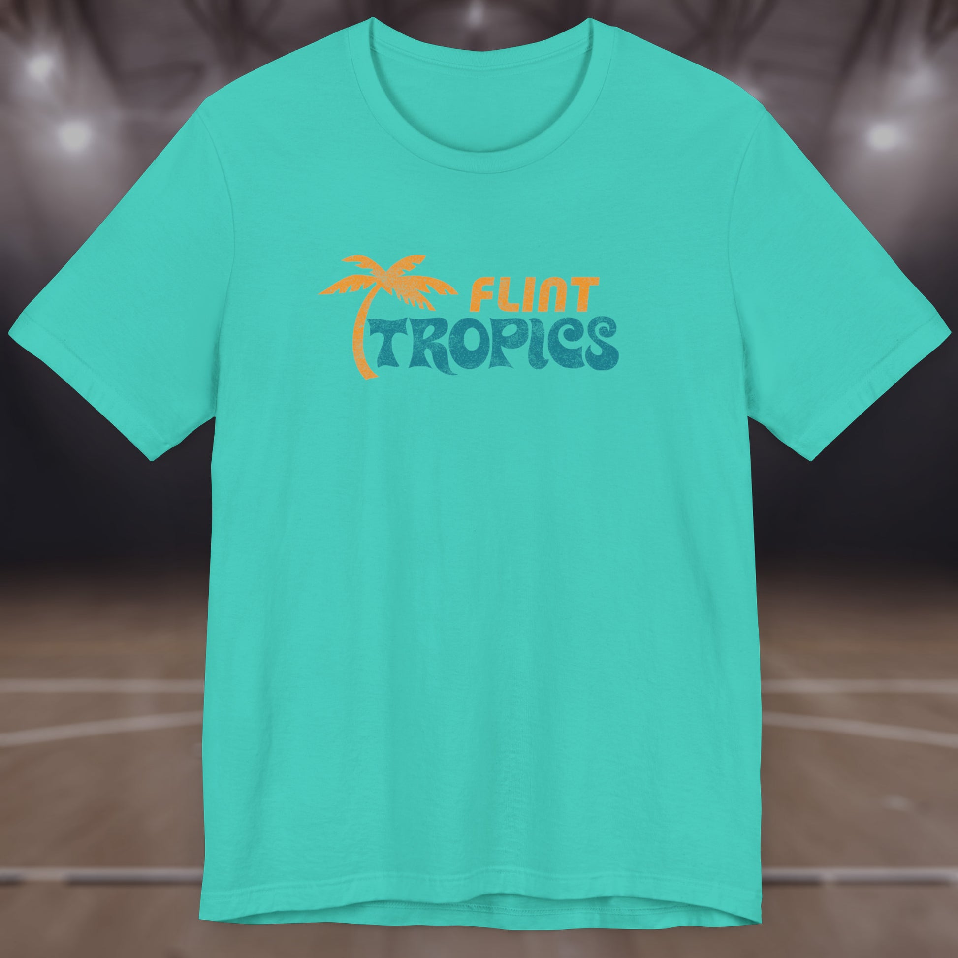Front view of a teal colored soft Bella+Canvas 3001 short-sleeve t-shirt tee featuring the Flint Tropics logo from the movie Semi-Pro, in a vintage distressed style, sold by ScriptedBrand.