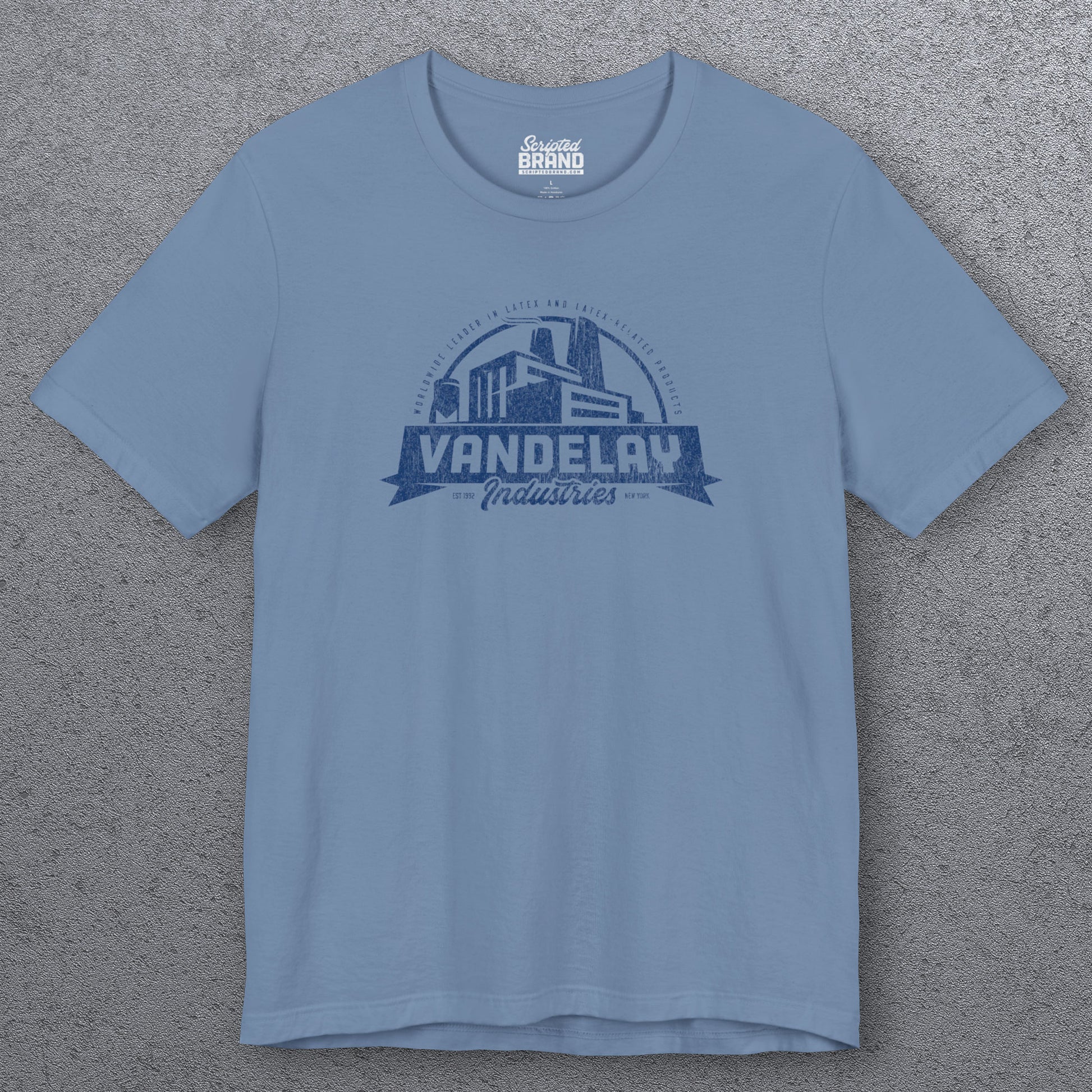 Front view of a steel blue Soft Bella+Canvas 3001 short-sleeve t-shirt tee featuring a Vandelay Industries logo graphic, uniquely designed by ScriptedBrand in a vintage distressed style. The fictional company is part of the George Costanza storyline in the TV show Seinfeld. 