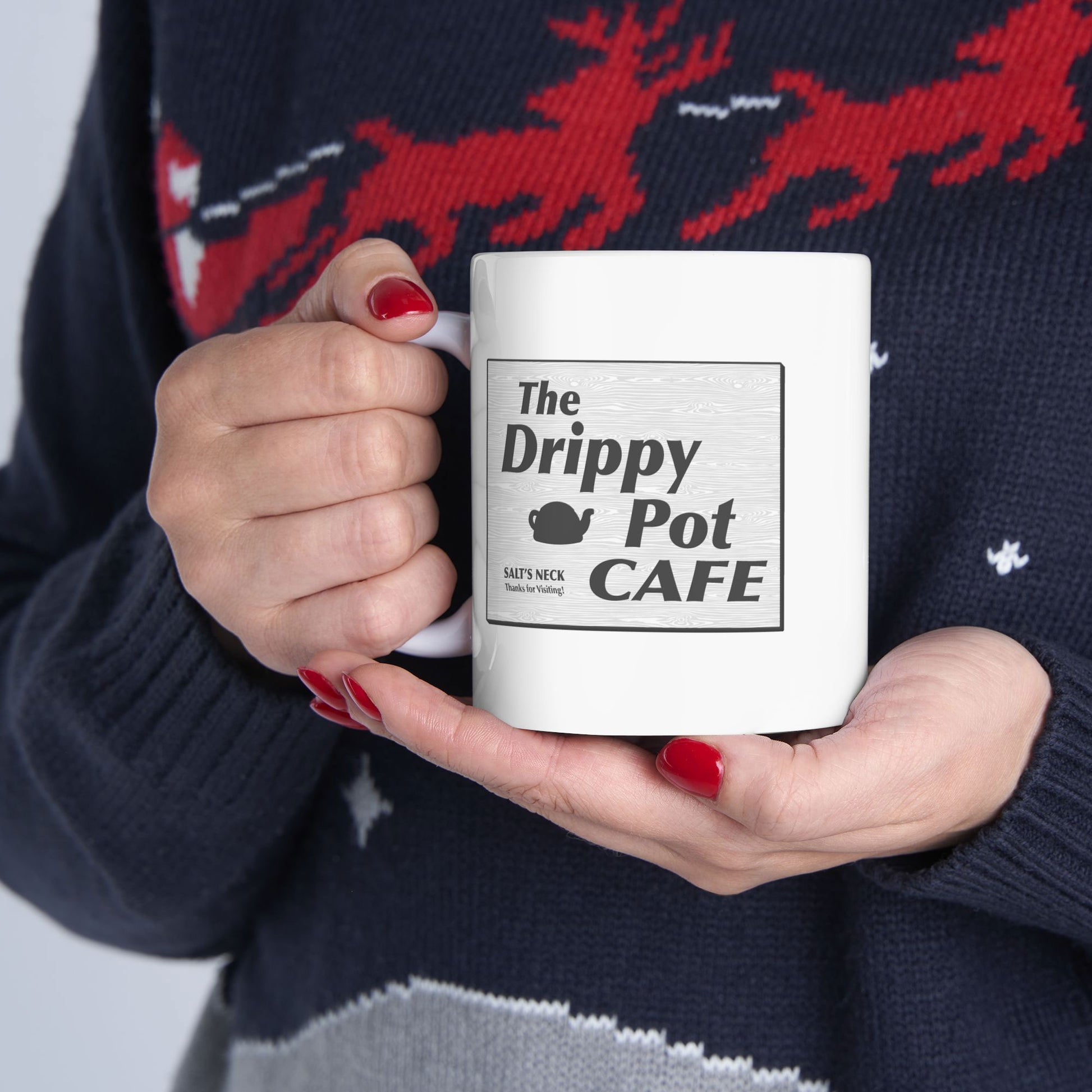 woman holding 11 oz White Ceramic Mug with the Drippy Pot Cafe logo graphic from the TV show Severance printed on both sides