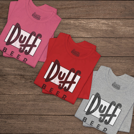 Three folded t-shirts featuring the Duff Beer logo from the TV Show The Simpsons in vintage distressed style.
