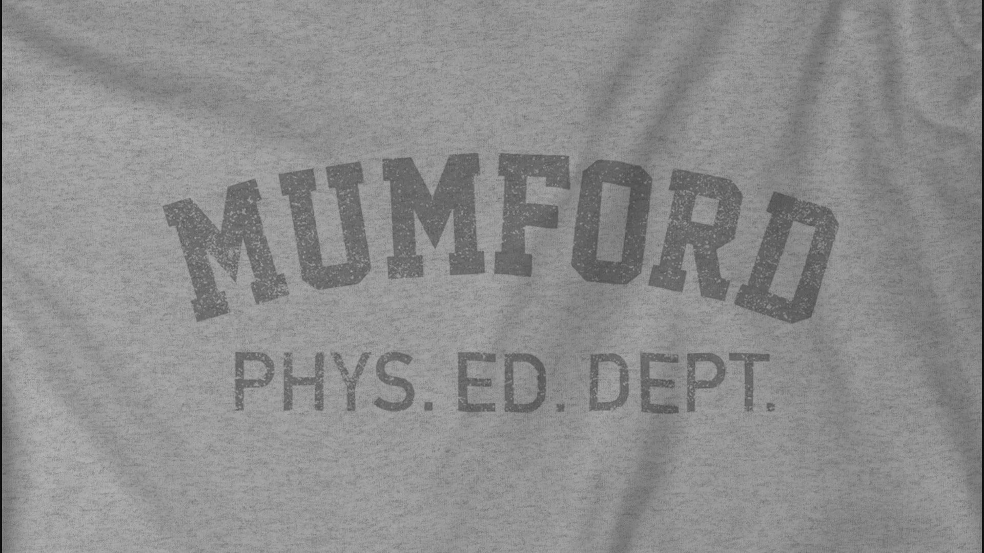 Video closeup of an athletic Heather Grey Soft Bella+Canvas 3001 short-sleeve t-shirt gym tees featuring the Mumford Phys Ed logo graphic that Eddie Murphy wore as Axel Foley in the movie Beverly Hills Cop in a vintage distressed style, sold by ScriptedBrand.