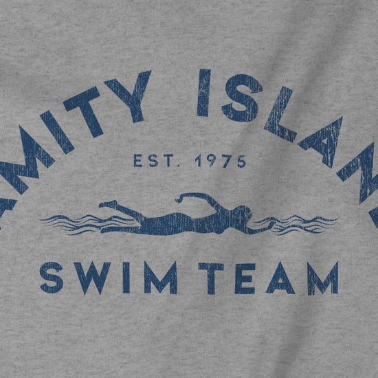 Video closeup of a Soft unisex Youth Sizes Bella+Canvas 3001Y short-sleeve t-shirts featuring an Amity Island Swim Team logo graphic, designed by ScriptedBrand, and  inspired by the movie Jaws in a vintage distressed style.