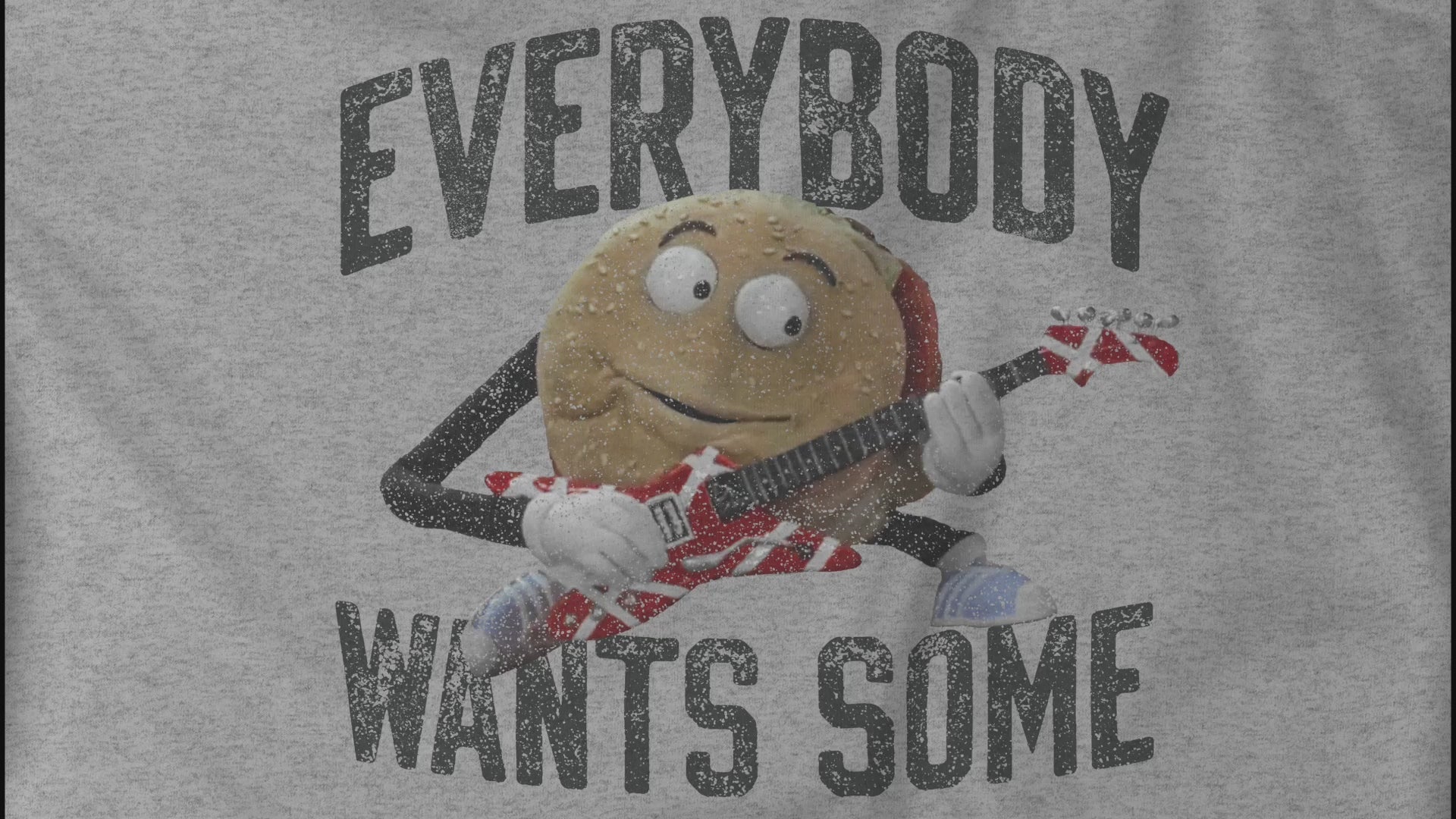 Video of a graphic shirt featuring the phrase EVERYBODY WANTS SOME with a graphic of the Van Halen singing hamburger playing guitar from the movie Better Off Dead, designed by ScriptedBrand in a vintage distressed style.