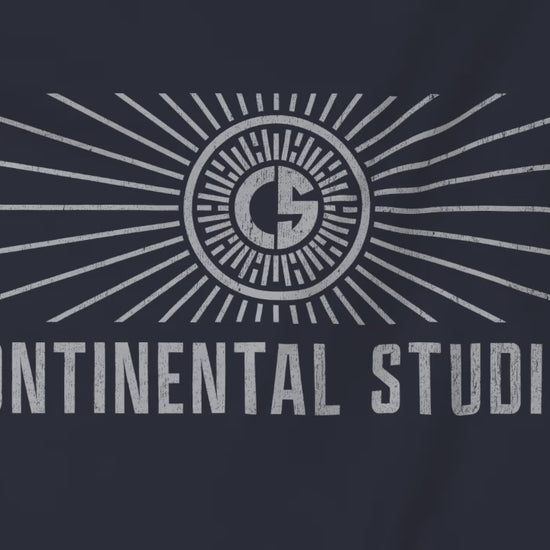 Video closeup of Soft Bella+Canvas 3001 short-sleeve t-shirt featuring the logo graphic of the fictional movie studio Continental Studios inspired by the Apple TV show The Studio in a vintage distressed style, sold by ScriptedBrand.