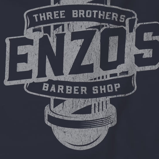 Video closeup of soft unisex Bella+Canvas 3001 short-sleeve t-shirts featuring a unique Enzo's Barber Shop logo graphic, designed by ScriptedBrand in a vintage distressed style, and inspired by the TV show Seinfeld.