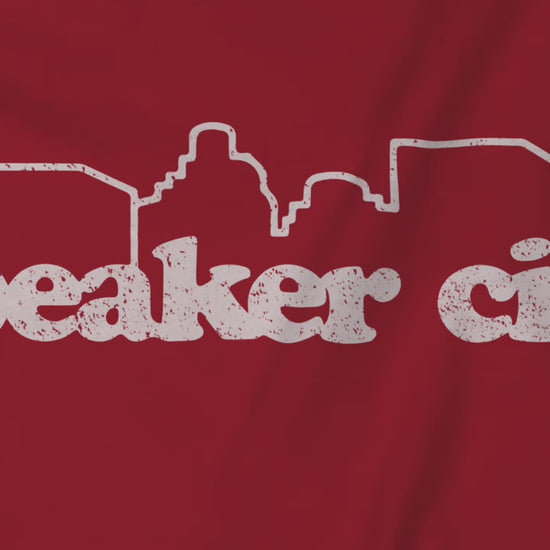 Video of t-shirts featuring the Speaker City logo from the movie Old School in a vintage distressed style and skyline outline.