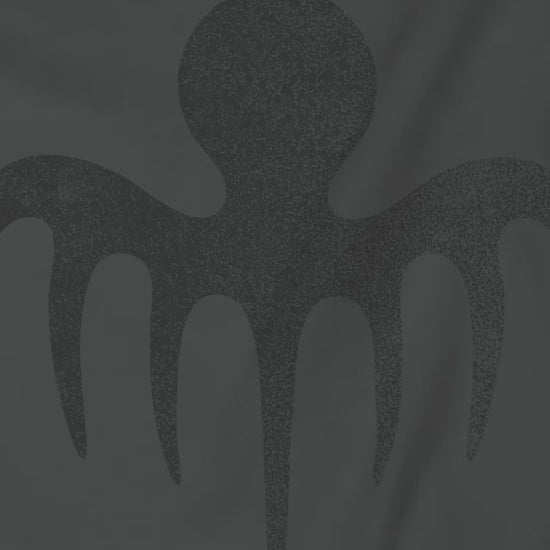 Video showing soft Bella+Canvas 3001 short-sleeve t-shirts featuring a logo graphic of the fictional criminal organization Spectre, inspired by the James Bond movie franchise, in a vintage distressed style.