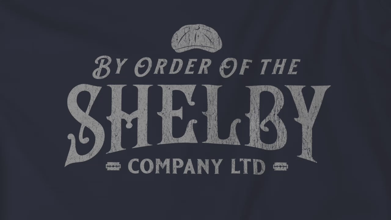 Video of soft short-sleeve Bella+Canvas 3001 t-shirts featuring a unique Shelby Company Limited logo graphic from the show Peaky Blinders and movie The Immortal Man, in a vintage distressed style, includes a flat cap and razor blades, designed and sold by ScriptedBrand.