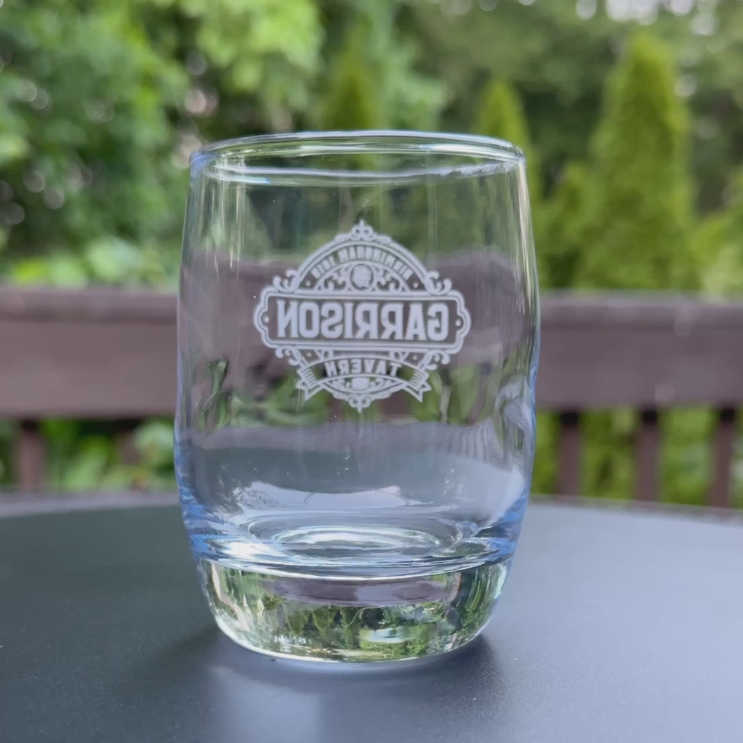 Video of 6 ounce Whiskey Glass featuring the Garrison Tavern Logo inspired by the TV show Peaky Blinders printed on one side.