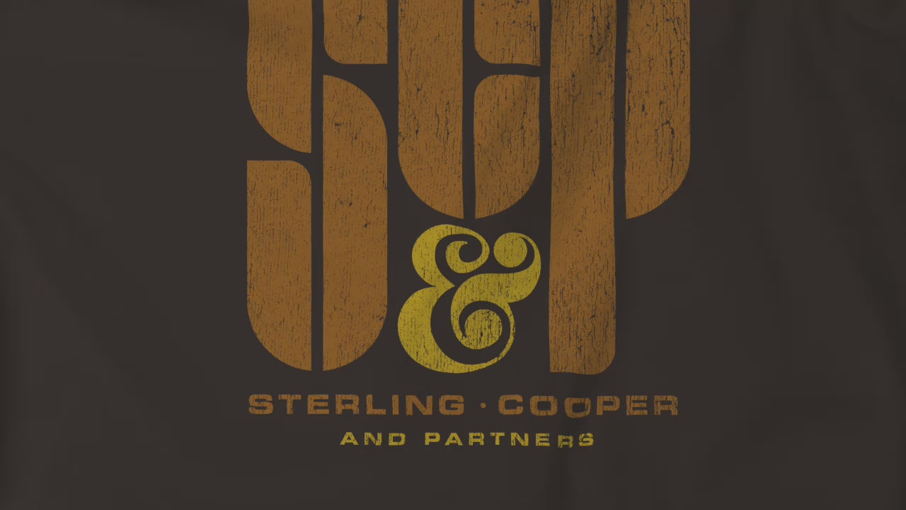 Video closeup of soft unisex Bella+Canvas 3001 short-sleeve t-shirts featuring the Sterling Cooper & Partners logo graphic from the TV Show Mad Men in a vintage distressed style, sold by ScriptedBrand.